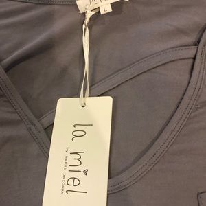 Beautiful soft material. This shirt has a cutout at the neckline on the front.